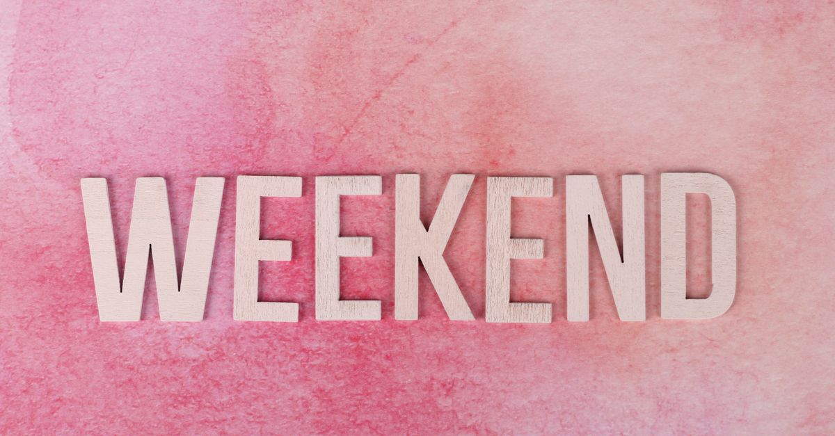 Creative display of the word 'Weekend' in wooden letters on a textured pink background.